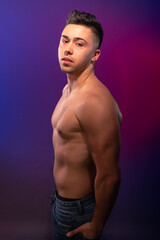 Handsome man posing at the studio without clothes at the torso
