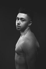 Fototapeta premium Handsome man posing at the studio without clothes at the torso