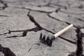 rake is on cracked ground, tines up