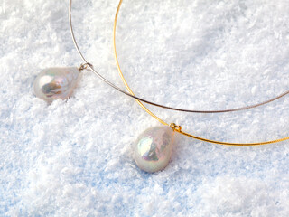 Luxury elegant baroque pearl pendants on white snow background