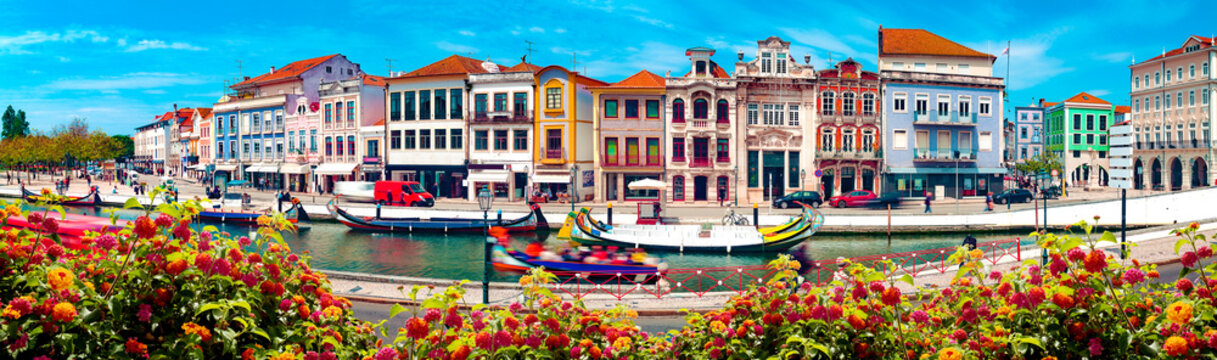 Traditional boats on the canal in Aveiro, Portugal. 
Aveiro River on a sunny afternoon on a summer day