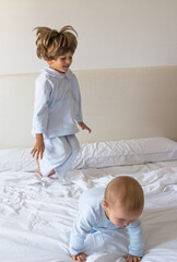 Fototapeta premium Brothers Playing On The Bed In Pajamas. Family Lifestyle