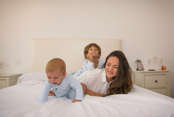 Mom And Children Playing.
A Mother And Her Children Play In Bed. Family Lifestyle.