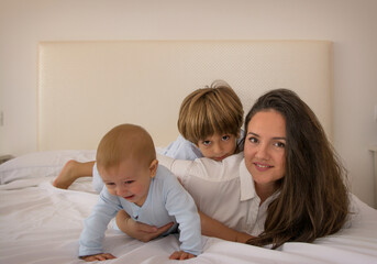Mom And Children Playing.
A Mother And Her Children Play In Bed. Family Lifestyle.