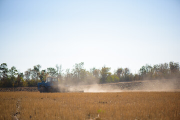 Fototapeta na wymiar Tractor plowing fields -preparing land for sowing