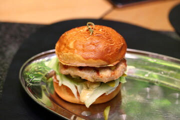 Grilled burger with meat patty, tomato and cheese