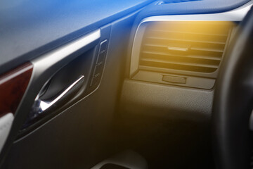 Car air heating concept. Hot air from the vent panel grille of a modern car.