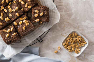 Homemade brownies with caramel sauce and peanuts, top view
