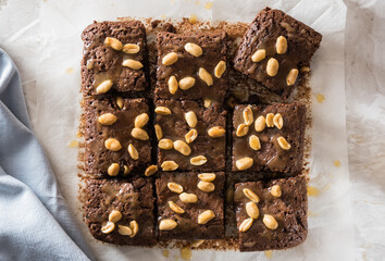 Homemade brownies with caramel sauce and peanuts, top view