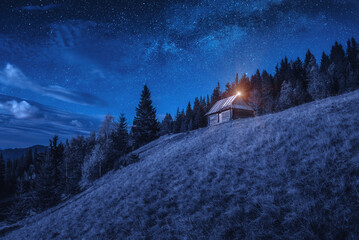 Fototapeta na wymiar Valley with shepherd's wooden house at night