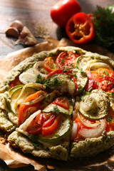 Autumn pie with vegetables. Shortbread dough with tomatoes, zucchini, onion and pepper baked in the oven. Fresh herbs, garlic, fork on an old wooden table. Rustic. Copy space. Top view, flatlay