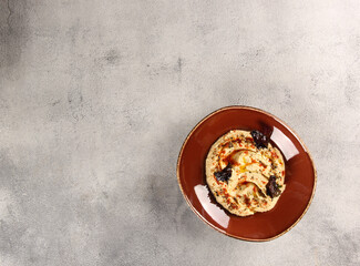Oriental cuisine. Appetizer. A mixture of young cheeses with radishes, garlic and herbs in the brown bowl on grey table. Restaurant menu. Background image, copy space. Top view, flatlay