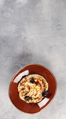 Oriental cuisine. Appetizer. A mixture of young cheeses with radishes, garlic and herbs in the brown bowl on grey table. Restaurant menu. Background image, copy space. Top view, flatlay