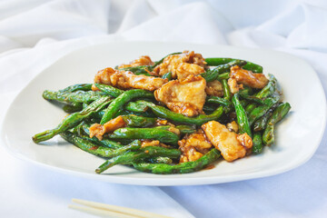 A view of a plate of green bean chicken.