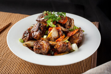 A view of a plate of marinated beef cube.