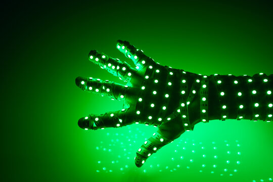 human hand covered with green led lights, illuminated background - Powered by Adobe