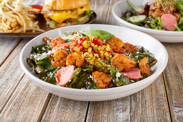 A view of several New American style entrees, featuring a Southwestern Tex-Mex shrimp salad.