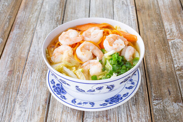 A view of a bowl of shrimp noodles soup.