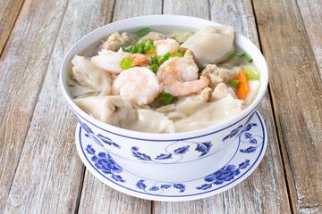 A view of a bowl of shrimp wonton soup.