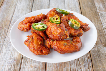 A view of a plate of spicy Chinese chicken wings.