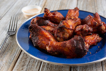 A view of a plate of deep fried chicken wings, in a restaurant or kitchen setting.