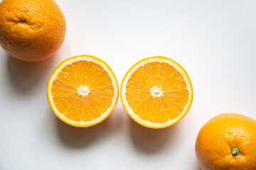 one orange cut and two whole