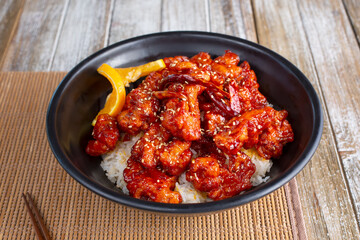 A view of a bowl of orange chicken.