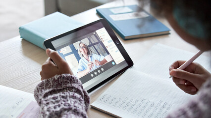African american school kid child girl holding digital tablet talking to remote teacher tutor on...