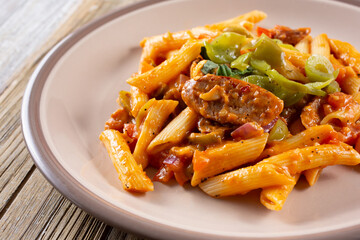 A view of a plate of sausage and peppers Arrabiata