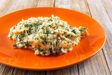 A view of a plate of spinach risotto.