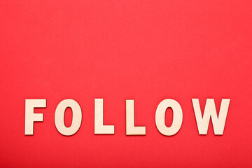 Word Follow by wooden letters on red background