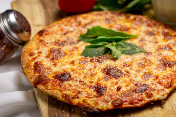 A view of a cauliflower crust cheese pizza on a wood board.