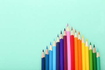 Colored pencils on mint background