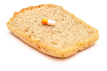 Fototapeta na wymiar Two capsule life symbols with medicines and bread on white background
