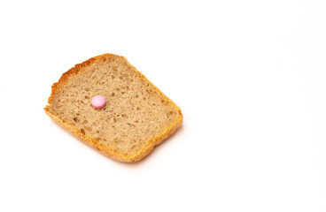 Pink pill and toast bread on a white background