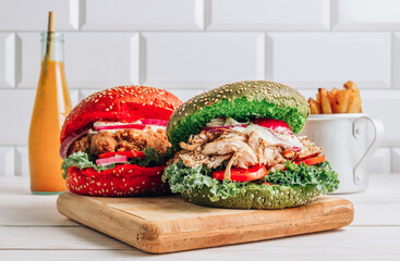 Homemade various chicken burger with colorful buns, kale, red onion, tomato and mayonnaise sauce