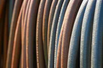 Water hoses in a row shot with selective focus 