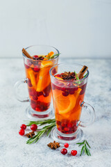 Orange and cranberry drinks with orange slices and spices. Hot drinks for winter and Christmas