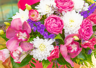 bright bouquet of pink roses and orchids