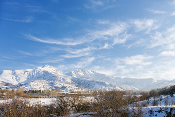 Beautiful winter in the mountains with snow. Winter Paradise in Central Asia with frosty conditions. Uzbekistan, not far from the Chimgan mountains in the cold and snowy winter.