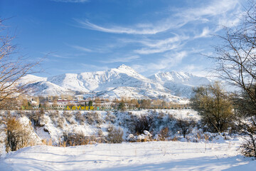 Fototapeta na wymiar Layner, the village of Chimgan, Uzbekistan. Winter mountain snow landscape. Tien Shan Mountains