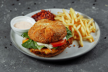 Fresh and fried fish burger with vegetables