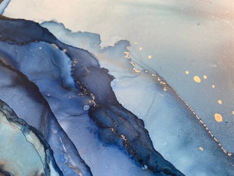 Blue sapphire abstract backgroud with stains made with alcohol ink and gold pigment