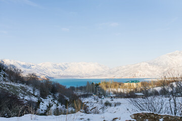 Charvak reservoir with blue water on a clear winter day in Uzbekistan