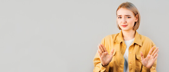 Woman thinks boyfriend should slow down. Portrait of calm displeased cute woman pulling palms...