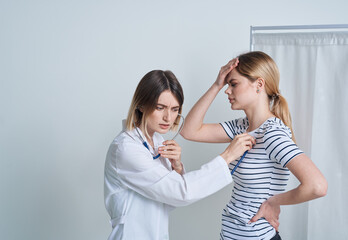 woman at the doctor's appointment medical gown stethoscope health