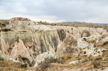 Fototapeta na wymiar Unique colorful sandstone rock formations in the Rose Valley. Central Anatolia, Cappadocia, Turkey