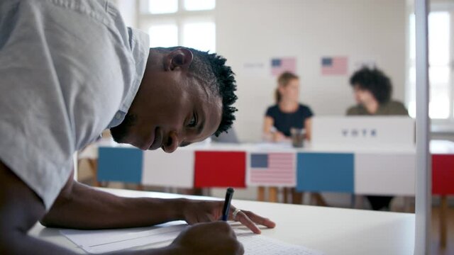 African-american man voter in polling place, usa elections concept.
