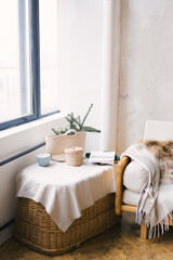 Part of the living room in the Scandinavian style, decorated for Christmas or New Year. Pine branches in a wicker bag