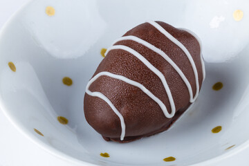 Chocolate truffles with strawberry filling isolated on white background. Closeup photography.